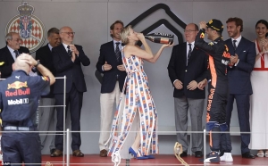 Princess Charlene drinks champagne offered by winning driver Daniel Ricciardo at the Monaco Grand Prix